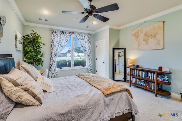 carpeted bedroom with visible vents, ornamental molding, ceiling fan, and baseboards