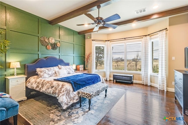 bedroom with ceiling fan, dark hardwood / wood-style flooring, and beam ceiling