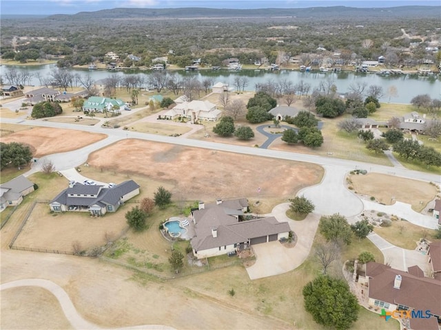 birds eye view of property with a residential view and a water view