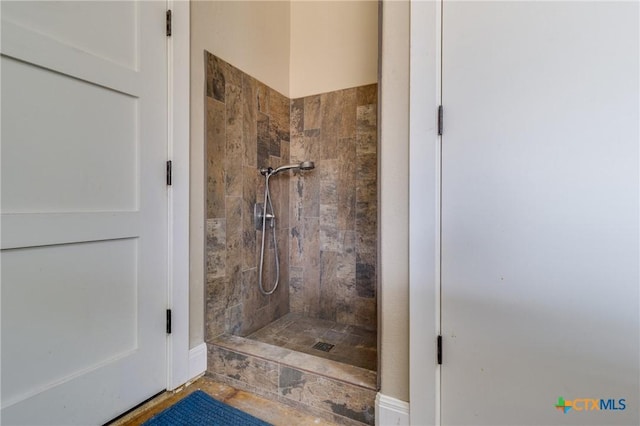 bathroom with a tile shower