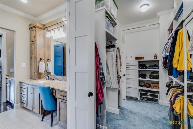 walk in closet featuring sink and light tile patterned floors