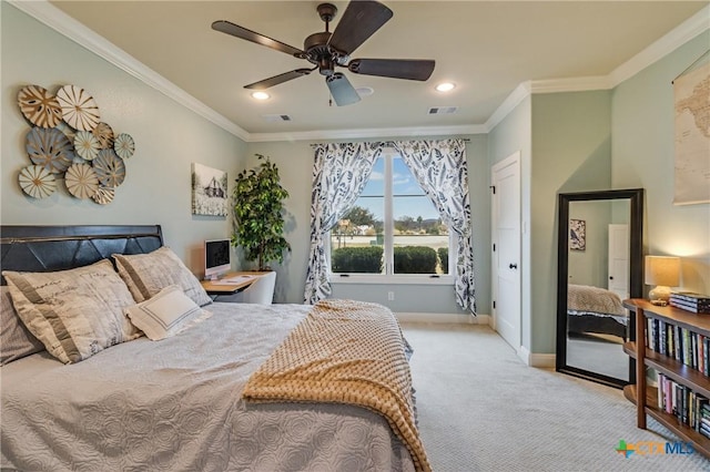 carpeted bedroom featuring ceiling fan, ornamental molding, visible vents, and baseboards