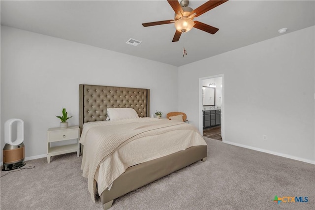 bedroom with connected bathroom, carpet flooring, and ceiling fan