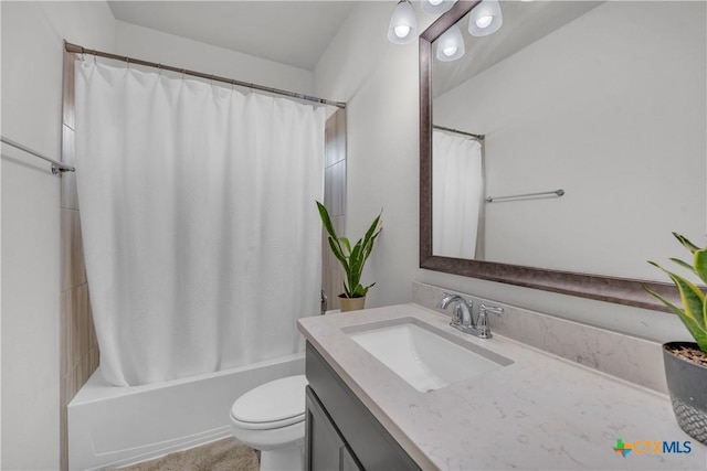 full bathroom with toilet, shower / bath combo with shower curtain, and vanity