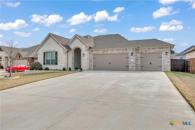 french country style house featuring a front yard and a garage