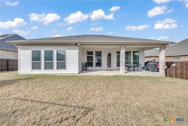 rear view of property with a patio area and a lawn