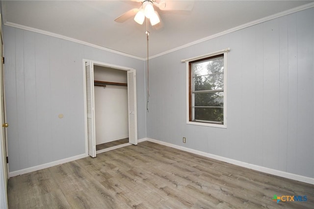 unfurnished bedroom featuring wood finished floors, baseboards, and ornamental molding