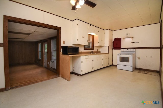 kitchen with electric range, light floors, white cabinets, and stainless steel microwave