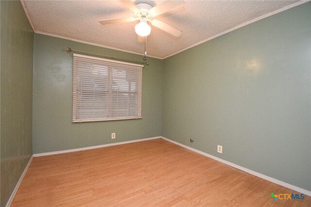 spare room featuring ceiling fan, a textured ceiling, wood finished floors, and ornamental molding