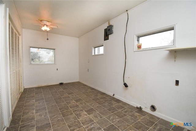 laundry area featuring baseboards, a ceiling fan, and laundry area