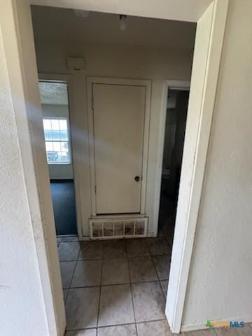 hall with light tile patterned flooring