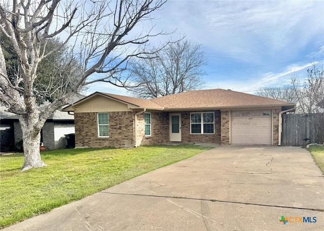 single story home with a front yard and a garage