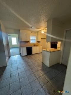 kitchen with tile patterned flooring and white cabinets