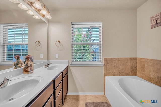 bathroom featuring tile patterned flooring, vanity, and a bathtub