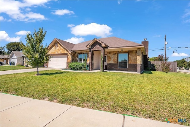 view of front of home with a garage and a front lawn