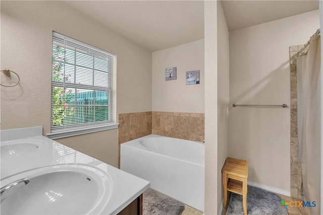 bathroom featuring a tub and vanity