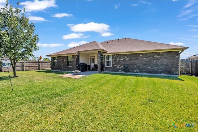 rear view of property featuring a patio area and a lawn