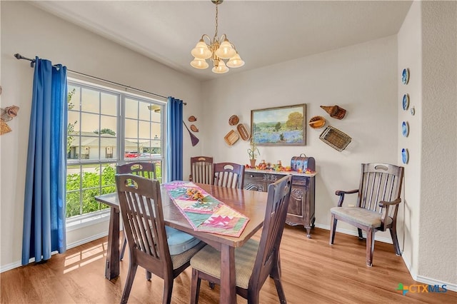 dining space featuring a chandelier and light hardwood / wood-style flooring