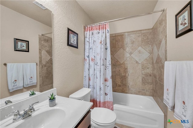 full bathroom with vanity, toilet, shower / tub combo, and a textured ceiling