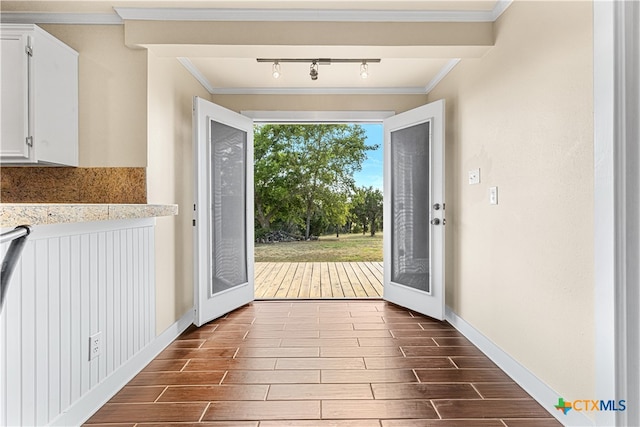 entryway featuring french doors, crown molding, and track lighting