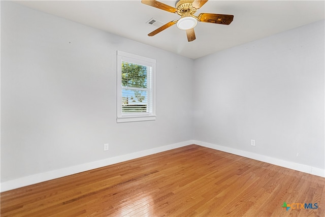 spare room featuring ceiling fan and wood-type flooring