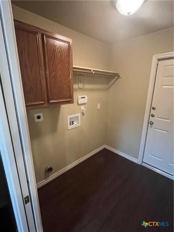 clothes washing area featuring baseboards, dark wood finished floors, hookup for a washing machine, cabinet space, and hookup for an electric dryer