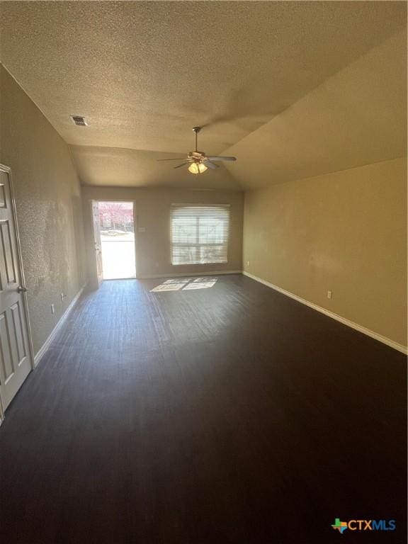 interior space featuring visible vents, lofted ceiling, a textured ceiling, and ceiling fan