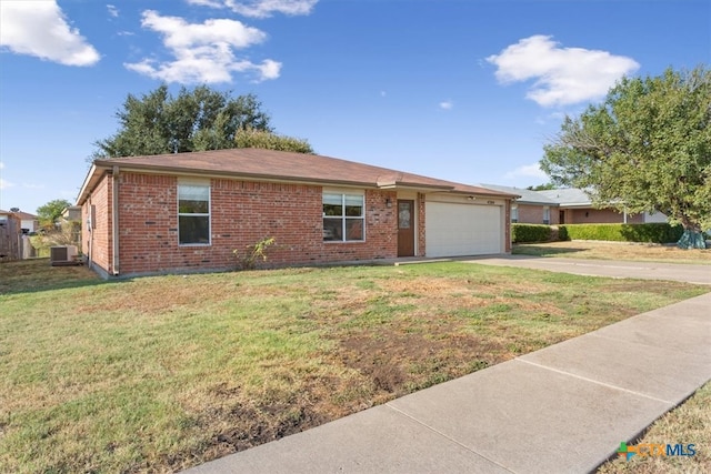 ranch-style home featuring a garage, central AC unit, and a front lawn