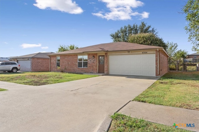 single story home with a garage and a front lawn