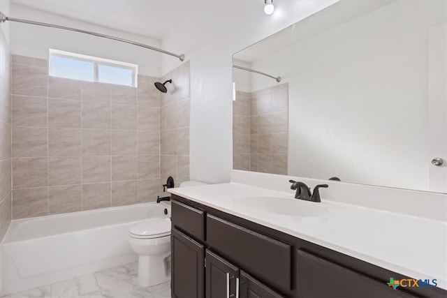 full bathroom featuring toilet, vanity, and tiled shower / bath