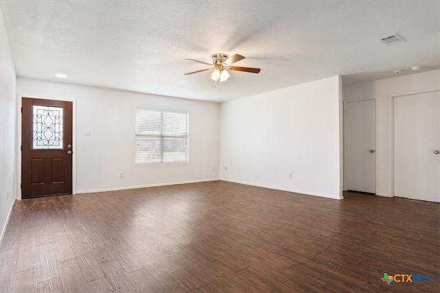 interior space featuring ceiling fan, a textured ceiling, and dark hardwood / wood-style flooring