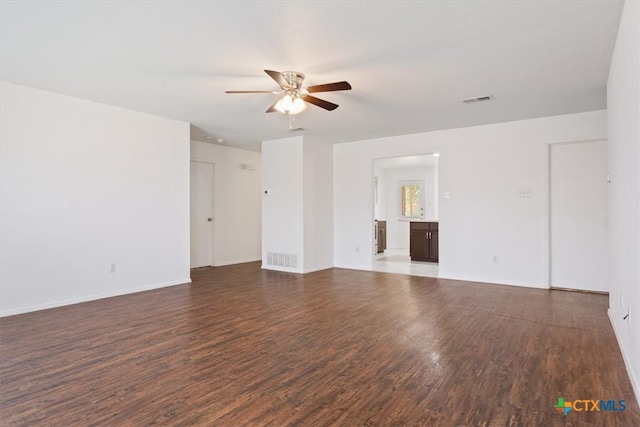 unfurnished room with dark hardwood / wood-style floors and ceiling fan