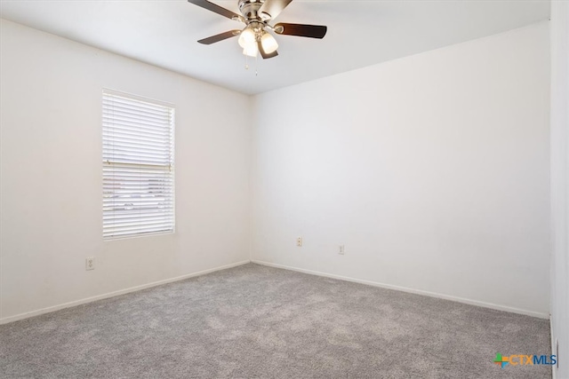 carpeted spare room with ceiling fan