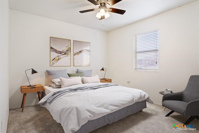 bedroom featuring light colored carpet and ceiling fan