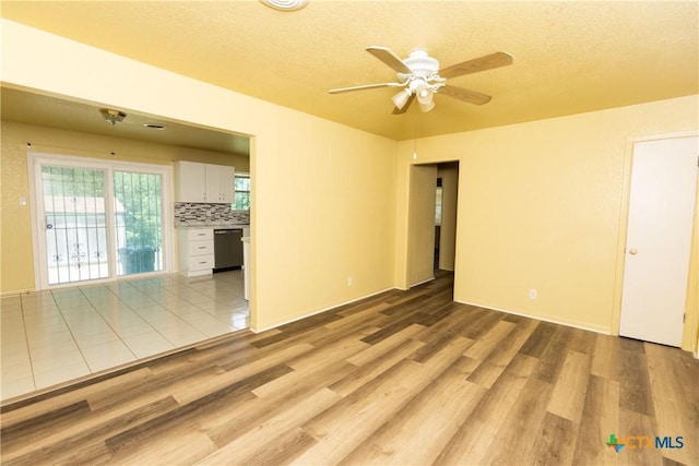 3003 Zephyr Rd, Killeen, TX 76543 - unfurnished room featuring light wood finished floors, a ceiling fan, and a textured ceiling