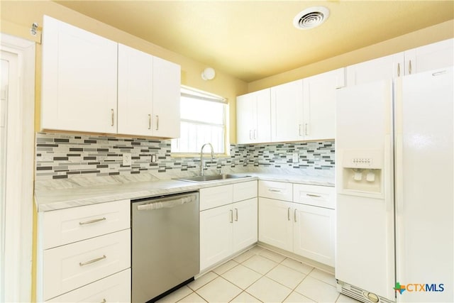 3003 Zephyr Rd, Killeen, TX 76543 - kitchen featuring white fridge with ice dispenser, dishwasher, light tile patterned floors, and decorative backsplash