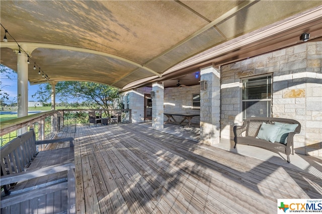 wooden terrace featuring ceiling fan