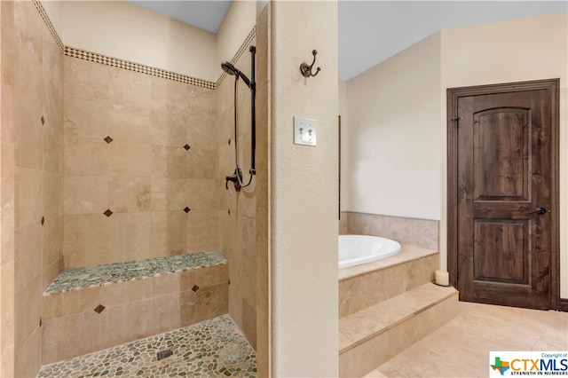 bathroom with tile patterned floors and independent shower and bath