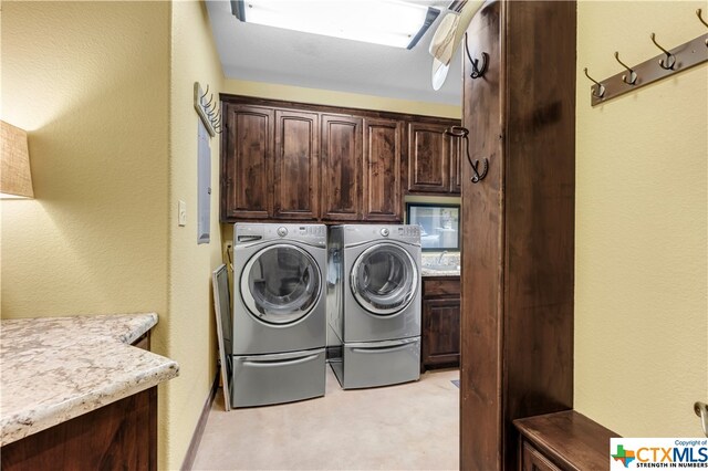 laundry area featuring light colored carpet, cabinets, and washer and dryer