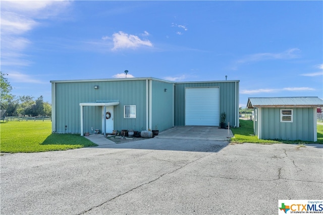 view of outbuilding with a garage and a yard