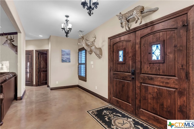 entryway featuring a wealth of natural light and a chandelier