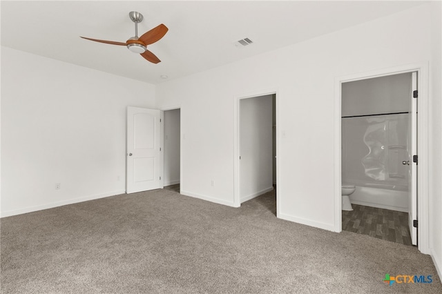 unfurnished bedroom with connected bathroom, carpet flooring, and ceiling fan