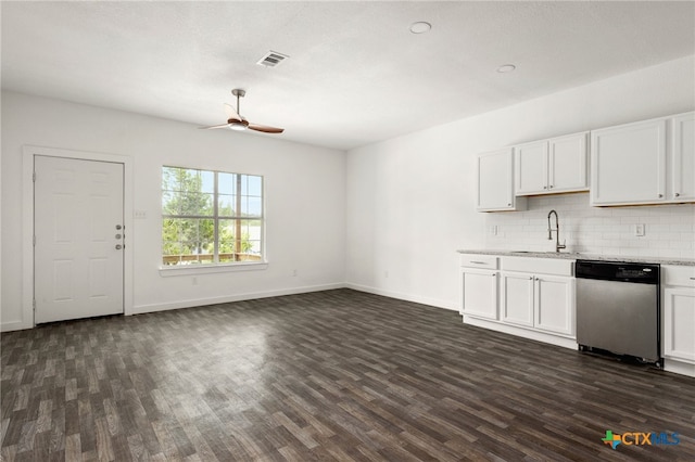 kitchen with dark wood-type flooring, stainless steel dishwasher, and white cabinets