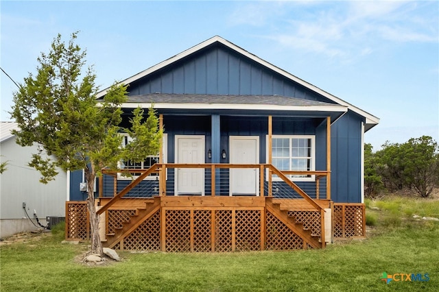 back of house featuring central AC unit and a yard