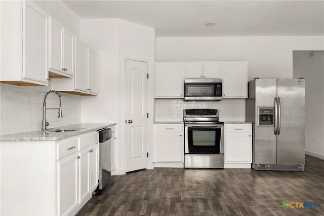 kitchen featuring dark wood-type flooring, white cabinetry, sink, and stainless steel appliances