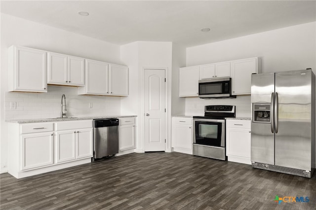 kitchen featuring white cabinetry, stainless steel appliances, dark wood-type flooring, and sink