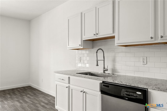 kitchen featuring wood-type flooring, light stone counters, white cabinetry, sink, and stainless steel dishwasher