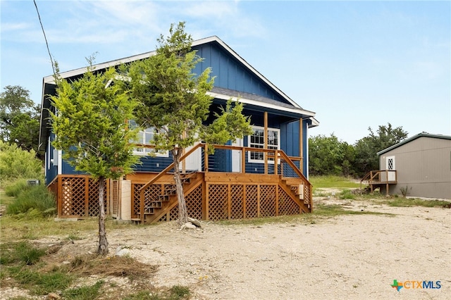 rear view of property featuring a deck