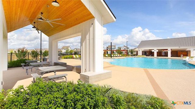 pool with fence, a patio, and ceiling fan