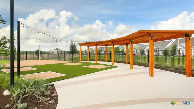 view of community featuring fence, a pergola, and a lawn